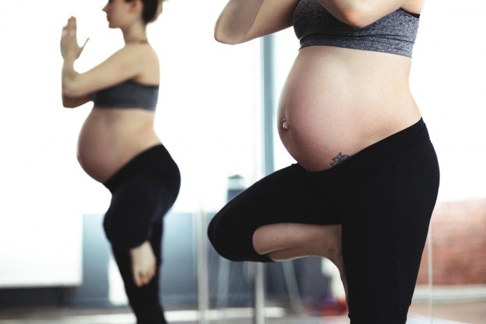A pregnant woman does yoga