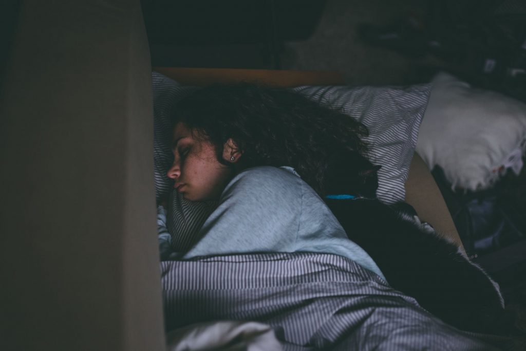 A woman with period pain sleeping